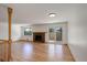 Bright living room with hardwood floors, brick fireplace, and sliding door to outdoor patio at 180 Dover St, Lakewood, CO 80226