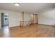 Open-concept living room featuring hardwood floors and staircase with wooden railing at 180 Dover St, Lakewood, CO 80226