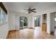Bright living room features hardwood floors, a ceiling fan, and sliding glass doors to the outside at 180 Dover St, Lakewood, CO 80226