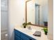 Bright bathroom featuring a blue vanity and a framed mirror at 1605 17Th St, Boulder, CO 80302