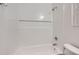 The renovated bathroom has clean white tiles and a modern showerhead and faucet set at 10001 E Evans Ave # 74C, Aurora, CO 80247