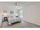 Bright bedroom with a ceiling fan and large window, complemented by neutral carpet at 10001 E Evans Ave # 74C, Aurora, CO 80247
