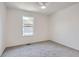 A serene bedroom with light walls, plush carpeting, and a window offering a pleasant view at 10001 E Evans Ave # 74C, Aurora, CO 80247