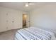 Bedroom with neutral carpet offers a ceiling fan and easy access to a closet and stairway at 10001 E Evans Ave # 74C, Aurora, CO 80247