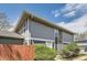 Two-story home with gray siding, stone accent column, and manicured landscaping at 10001 E Evans Ave # 74C, Aurora, CO 80247
