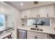 Bright kitchen boasts white cabinets, modern countertops, stainless steel appliances, and a pass-through window at 10001 E Evans Ave # 74C, Aurora, CO 80247