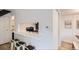 Modern kitchen with breakfast bar, white countertops, and view into the dining area at 10001 E Evans Ave # 74C, Aurora, CO 80247