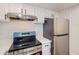 Updated kitchen features stainless steel appliances, white cabinets, and modern countertops at 10001 E Evans Ave # 74C, Aurora, CO 80247