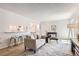 Cozy living area with modern furnishings, wood floors, and a pass-through to the kitchen at 10001 E Evans Ave # 74C, Aurora, CO 80247