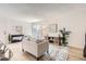 Open living room with wood floors, neutral decor, and natural light from the sliding doors at 10001 E Evans Ave # 74C, Aurora, CO 80247