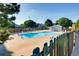 Outdoor community pool with lounge chairs and a wooden fence, perfect for relaxation at 10001 E Evans Ave # 74C, Aurora, CO 80247