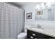 Bright bathroom with a shower and tub combination, vanity with granite countertop, and updated fixtures at 1155 N Ash St # 1408, Denver, CO 80220