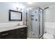 This bathroom features a glass enclosed shower, granite countertops, modern fixtures, and bright lighting at 1155 N Ash St # 1408, Denver, CO 80220