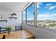 Bright dining area with a wooden table, chairs, and a large window offering views of the cityscape at 1155 N Ash St # 1408, Denver, CO 80220