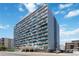 Modern high-rise apartment building with unique blue balcony design and street-level parking at 1155 N Ash St # 1408, Denver, CO 80220