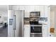 Modern kitchen with stainless steel appliances, granite countertops, and mosaic tile backsplash at 1155 N Ash St # 1408, Denver, CO 80220