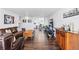 Open concept living area featuring hardwood floors, comfortable seating, and dining area beyond at 1155 N Ash St # 1408, Denver, CO 80220
