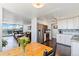 Bright, open living space with a dining area, kitchen, and living room featuring large windows and city views at 1155 N Ash St # 1408, Denver, CO 80220