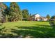 Large backyard with lush green grass and mature trees surrounding the property, offering privacy at 8000 S Williams Way, Centennial, CO 80122