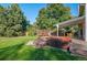 Large backyard with deck, hot tub, and mature trees for privacy and shade at 8000 S Williams Way, Centennial, CO 80122