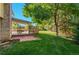 Outdoor covered living space with a patio and a spacious lawn, perfect for entertaining or relaxing at 8000 S Williams Way, Centennial, CO 80122