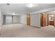 Large finished basement area with plush carpeting and multiple entryways, offering flexible living space at 8000 S Williams Way, Centennial, CO 80122