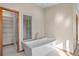 Bright bathroom features a soaking tub, glass shower, and built-in shelving, offering a spa-like experience at 8000 S Williams Way, Centennial, CO 80122