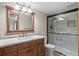 Well-lit bathroom featuring a vanity with a quartz countertop and a separate walk-in shower stall at 8000 S Williams Way, Centennial, CO 80122