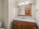 Cozy half bathroom features custom wood vanity with quartz countertop and modern fixtures at 8000 S Williams Way, Centennial, CO 80122