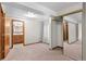 Bedroom with en-suite bathroom, plush carpet, closet, and neutral tones, offering flexible living space at 8000 S Williams Way, Centennial, CO 80122