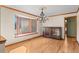 Traditional dining room features wood trim, hardwood floors, a bay window, and a decorative chandelier at 8000 S Williams Way, Centennial, CO 80122