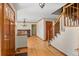 Inviting foyer with hardwood floors, a decorative chandelier, and a staircase with wood railings at 8000 S Williams Way, Centennial, CO 80122