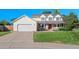 A sunny two-story home with a two-car garage and a lush green lawn in a suburban neighborhood at 8000 S Williams Way, Centennial, CO 80122