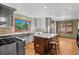 Bright, updated kitchen with stainless steel appliances, an island with seating, and hardwood floors at 8000 S Williams Way, Centennial, CO 80122