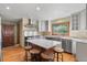Spacious kitchen featuring an island with seating, stainless steel appliances, and a large window at 8000 S Williams Way, Centennial, CO 80122