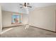 Spacious main bedroom featuring plush carpet, vaulted ceiling, fan, and bright windows with soft light at 8000 S Williams Way, Centennial, CO 80122