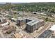 Aerial view showcasing a modern condo building surrounded by neighborhood and mountain views at 20 Wilcox St # 309, Castle Rock, CO 80104
