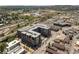 Aerial view showcases a building with commercial spaces, parking lots, and surrounding city landscape at 20 Wilcox St # 309, Castle Rock, CO 80104