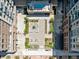 Aerial view of a courtyard features outdoor lounge areas, a pool, and landscaped gardens at 20 Wilcox St # 309, Castle Rock, CO 80104