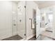 Bathroom featuring a glass-enclosed shower with white tile and an open doorway to the bedroom at 20 Wilcox St # 309, Castle Rock, CO 80104