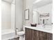 Bathroom featuring a tub/shower, dark-tone vanity with a sink and decorative artwork at 20 Wilcox St # 309, Castle Rock, CO 80104