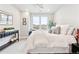 Bedroom featuring a soft white bed, decorative pillows, a large window with views, and a stylish console table at 20 Wilcox St # 309, Castle Rock, CO 80104