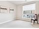 Bright room with chair, large window, neutral paint, and carpeted floor. Artwork adds touch of decor at 20 Wilcox St # 309, Castle Rock, CO 80104