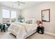 Bright bedroom with comfortable bed, ceiling fan, view of the city from the large window, and neutral decor at 20 Wilcox St # 309, Castle Rock, CO 80104