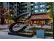 Attractive building entrance with modern sculpture, landscaping, and outdoor lighting at 20 Wilcox St # 309, Castle Rock, CO 80104