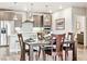 Bright dining room featuring a dark wooden table and kitchen in the background at 20 Wilcox St # 309, Castle Rock, CO 80104