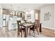 Bright dining room featuring a dark wooden table and kitchen in the background at 20 Wilcox St # 309, Castle Rock, CO 80104