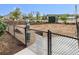 Fenced dog park including rules sign, waste station, and seating area surrounded by mulched landscape at 20 Wilcox St # 309, Castle Rock, CO 80104