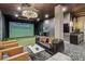 Resident golf simulator room featuring golf simulator screen, leather sofa, and sink at 20 Wilcox St # 309, Castle Rock, CO 80104