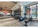 Bright gym featuring modern equipment, fitness rules poster, large windows, and inspiring mural at 20 Wilcox St # 309, Castle Rock, CO 80104